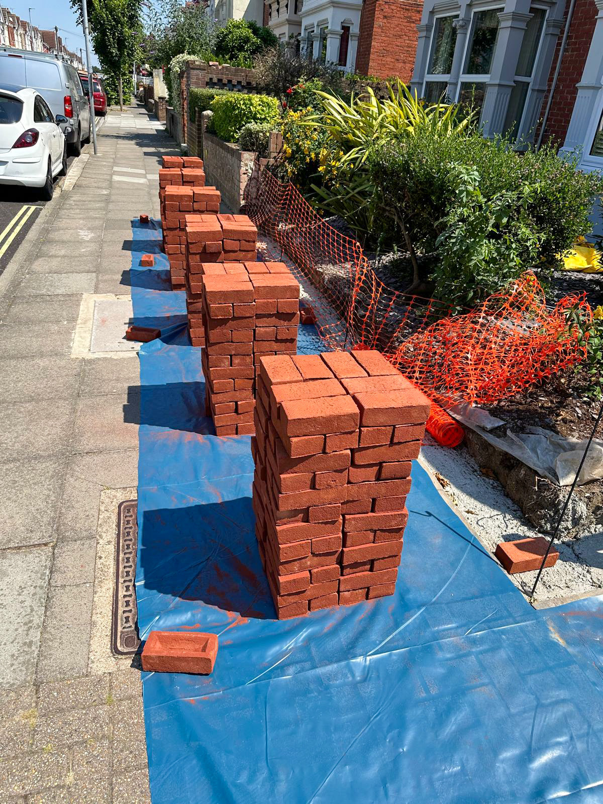 Bricks stacked on site before the new front garden wall was built