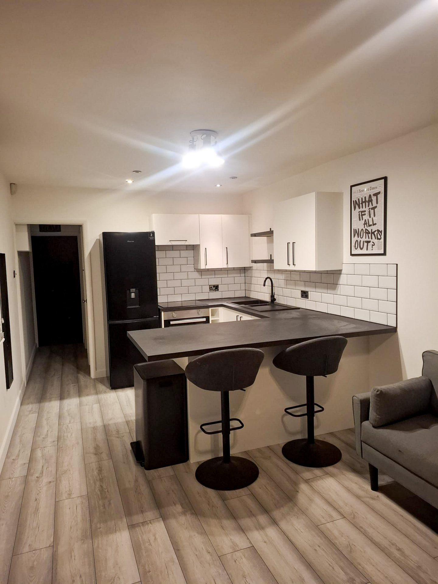 Modern open-plan kitchen after renovation with breakfast bar and metro tiles