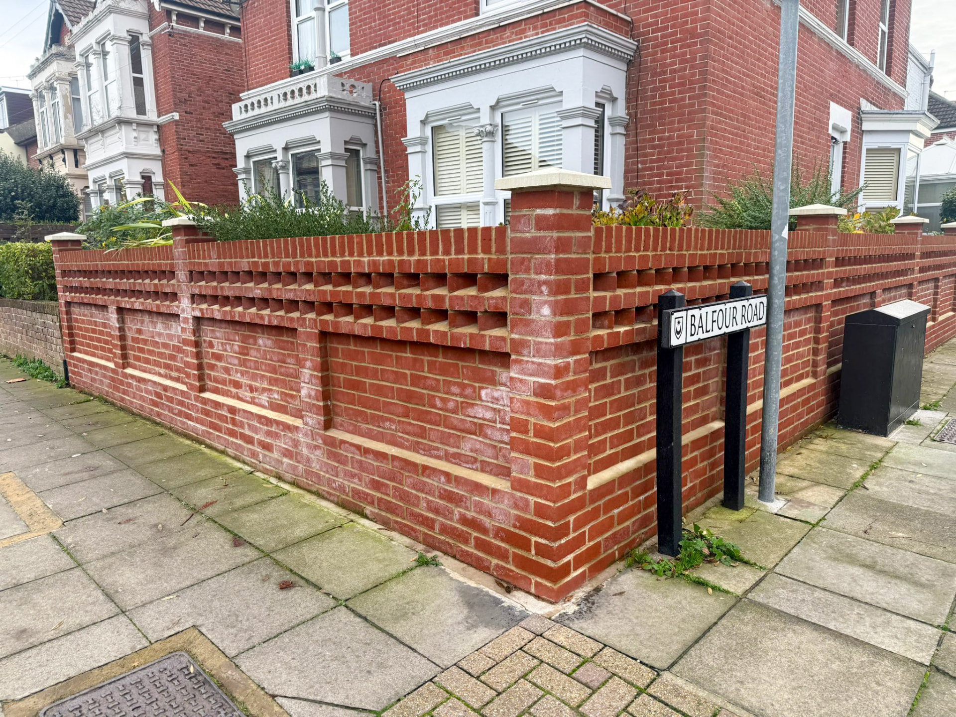 Completed red brick front garden wall with piers and stone copings